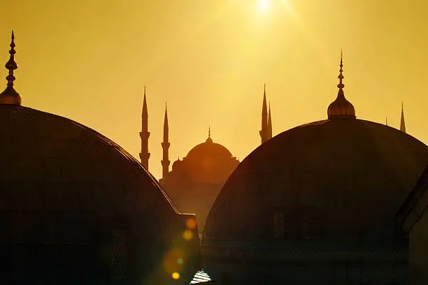 View from a window of Aya Sofya. Blue Mosque silhouette in the background. Istanbul, Turkey. Visible lens flare.
