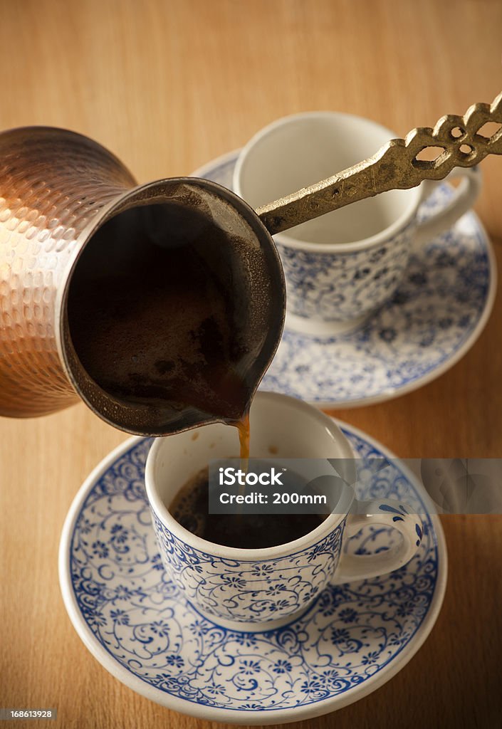 Pouring a Fresh Cup of Brewed Coffee Copper coffee pot and coffee cup Black Coffee Stock Photo