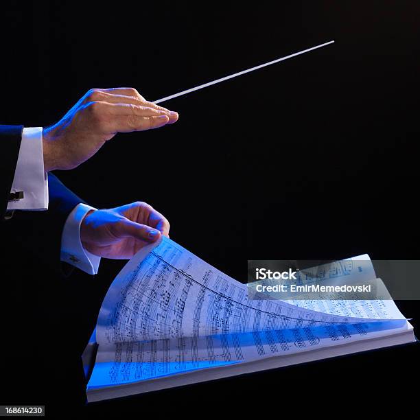 Hands Of A Conductor With A Baton And Musical Book Stock Photo - Download Image Now - Musical Conductor, Orchestra, Sheet Music