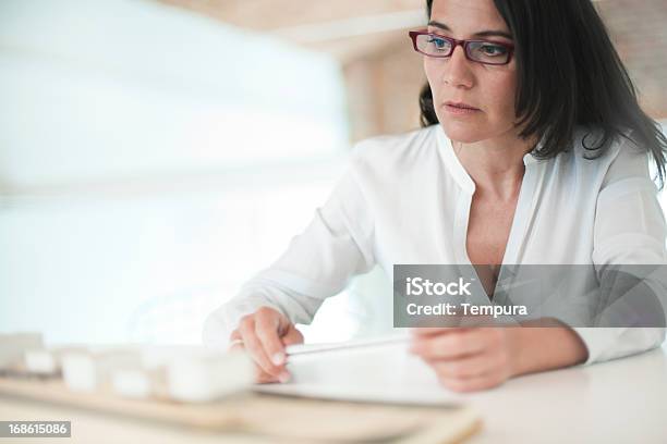Architecte Or Designer Looking At A Model On Her Studio Stock Photo - Download Image Now