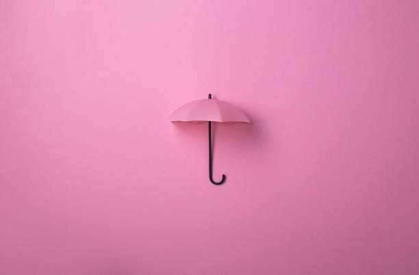 istock Pink umbrella isolated on purple background. 1686151287