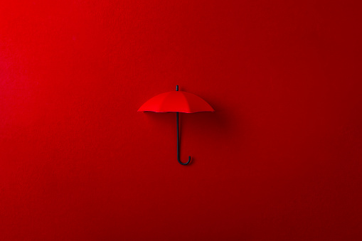 Red umbrella isolated on purple background. Invesment, business, summer concept