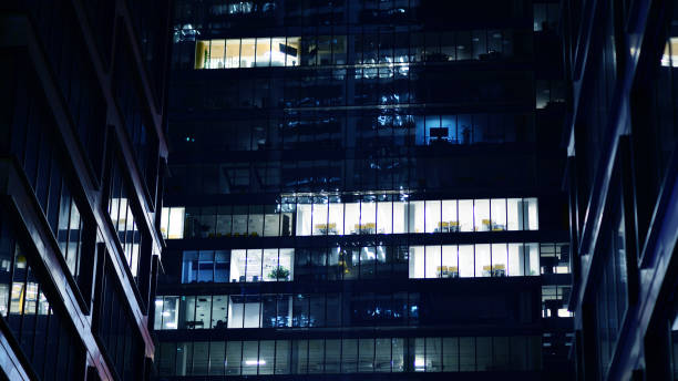istock Pattern of office buildings windows illuminated at night. 1686168786