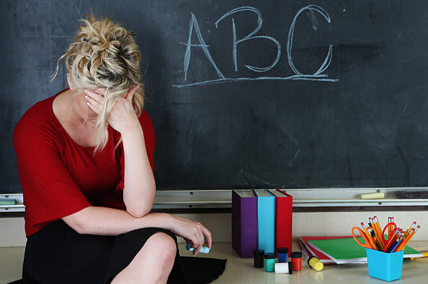 Frustrated elementary teacher stock photo