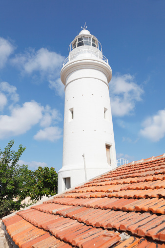 Paphos white lighthouse  red roof tiles  Cyprus against blue sky