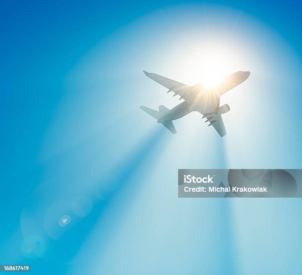 Passenger Airplane Flying Against The Sun Stock Photo - Download Image Now - Airplane, Sky, Sun
