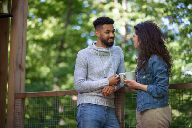 istock Happy couple resting and looking at camera outdoors in a tree house, weekend away and digital detox 1686186702