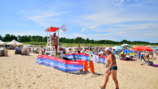 Lifeguards with rescue tower on the beach of the Baltic Sea