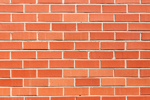 Closeup red brick wall, full frame horizontal composition with copy space