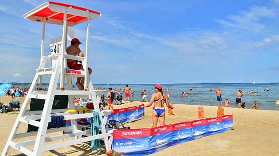 Lifeguards with rescue tower on the beach of the Baltic Sea