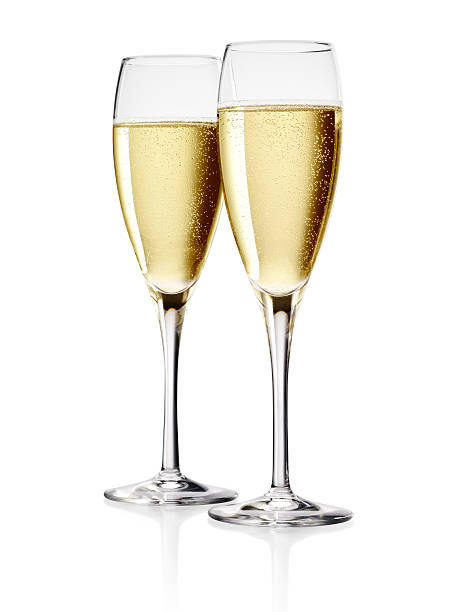 Champagne Two Flutes of Champagne isolated over white background. champagne stock pictures, royalty-free photos & images
