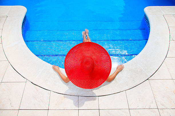 istock woman relaxing in a resort swimming pool 168619749