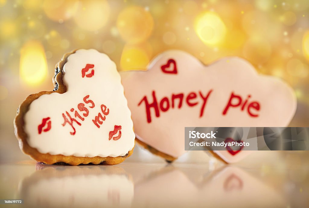 Valentine's Cookies Cute heart shaped Valentine's cookies with Honey pie and kiss me written on it. Arrangement Stock Photo