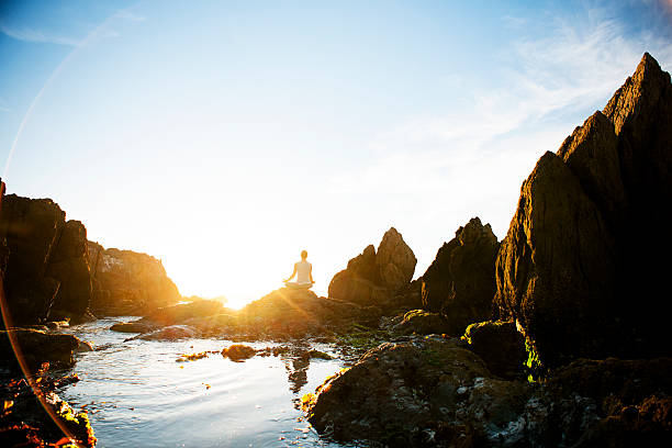 istock Female meditating on the rocks 168620093