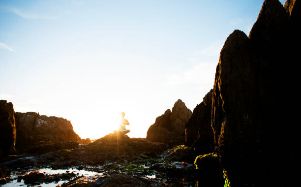 istock Female meditating on the rocks 168620137