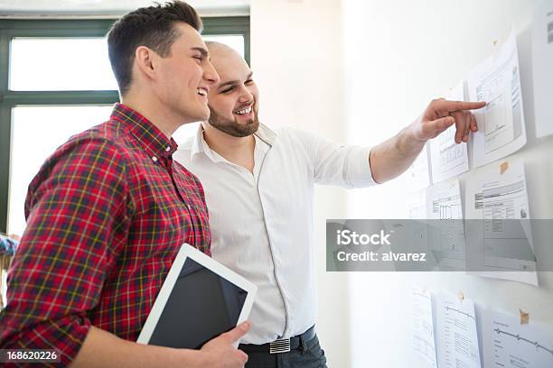 Two Colleagues At A Start Up Enjoying Work Stock Photo - Download Image Now - Discussion, Office, Adult