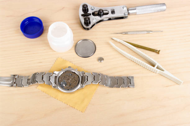 istock Gents Wristwatch With Back Removed And Tools For Battery Change 168620811