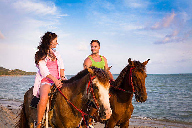 istock Couple riding horses at sunset 168620932