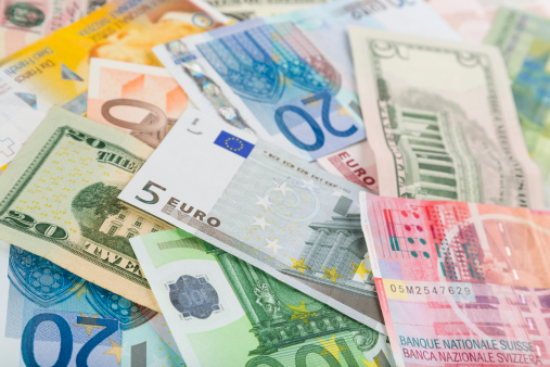 Stack of coins on euro banknotes as wide panoramic format, website header concept for business, finance or inflation, copy space, selected focus, narrow depth of field