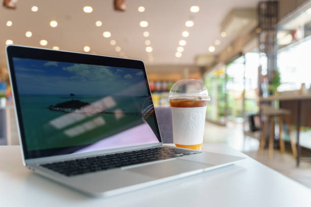 istock notebook (Laptop) on Copy space of table top counter on blur bokeh coffee cafe. 1686212686