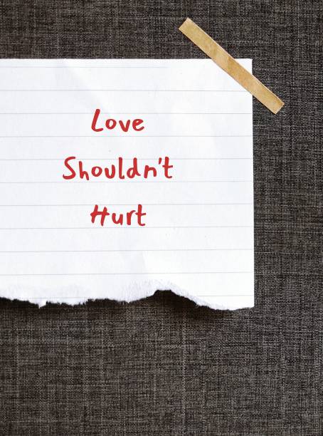 istock Torn note stick on grey background with handwritten LOVE SHOULD NOT HURT, means everyone deserves to be safe in relationship, should not be hurt by partner  physically, emotionally, or sexually 1686214833