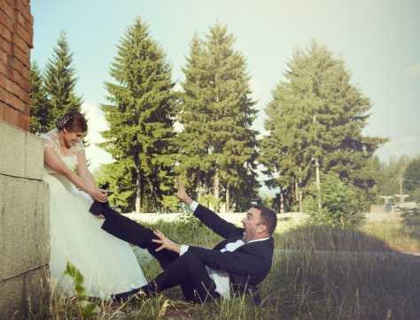 possesive bride pulling her screaming groom.