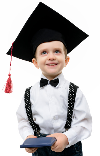 happy preschooler bpy wearing graduate hat.