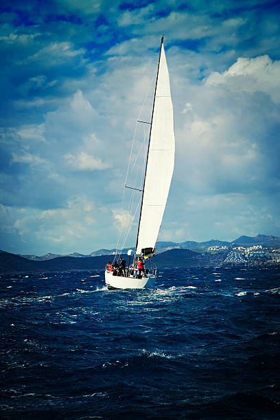 Sailing team on yatch and stormy weather.