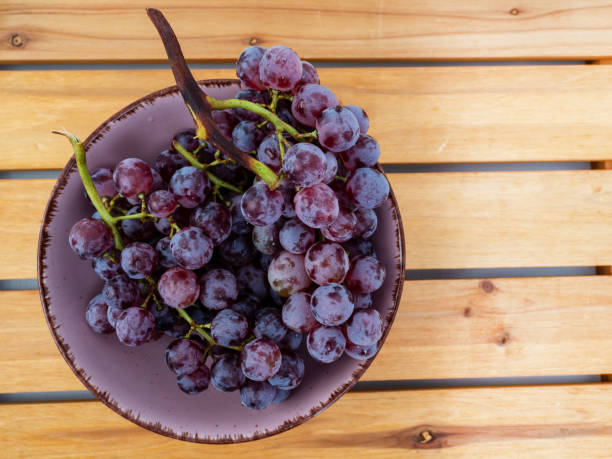istock Red grapes on a wooden background. 1686230790