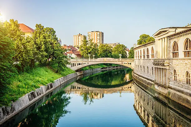 Bridge over Ljubljanica river in the late afternoon sun, one of the many famous bridges in the beautiful capital city of Ljubljana, Slovenia.