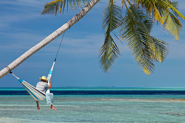 istock Beach relaxation in hammock hanged in paradise 168623587