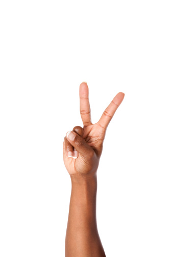 African American female making the letter V using American Sign Language.
