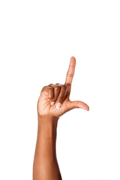 African American female making the letter L using American Sign Language.