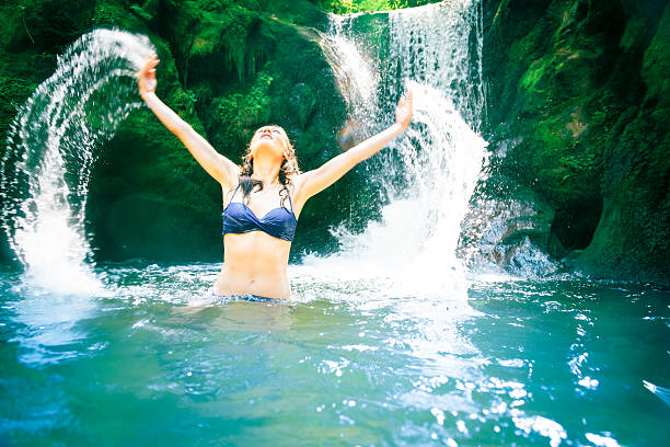 istock beautiful lady by the waterfall 168623897