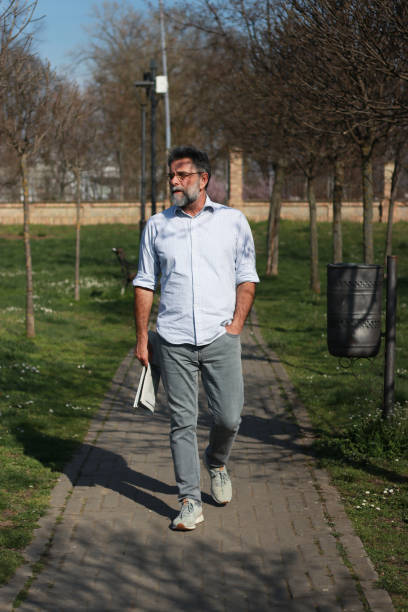 istock Senior man walking trough park 1686243453