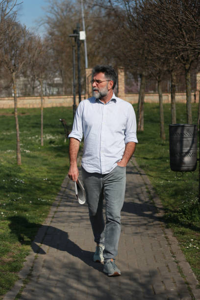 Senior man walking trough park