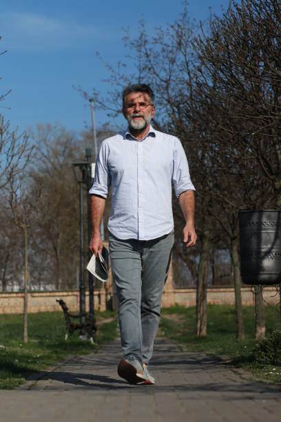 istock Senior man walking trough park 1686243979