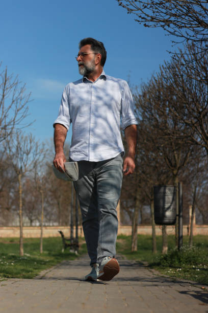 istock Senior man walking trough park 1686243987