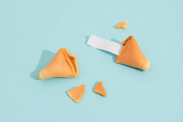 istock Fortune cookie on a blue background with deep long shadow. Blank paper for prediction words 1686260403