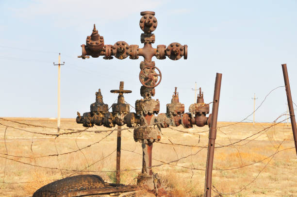 Oil industry: Abandoned wellhead An abandoned wellhead in the oil field. The well is not producing anymore. oil wellhead stock pictures, royalty-free photos & images