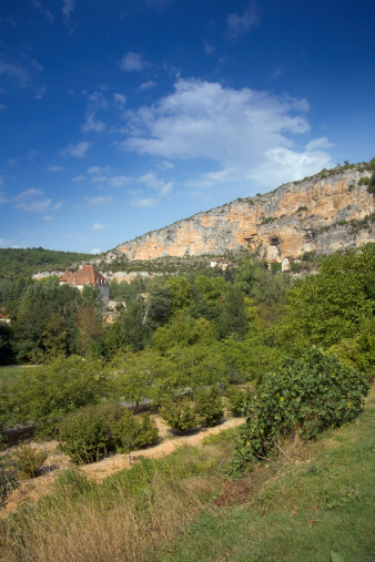 Europe, France, Quercy, Lot, old stone houses are built on the cliffs above the village at Sauliac Sur Cele