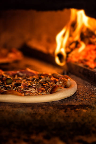 pizzas baking in traditional fire oven