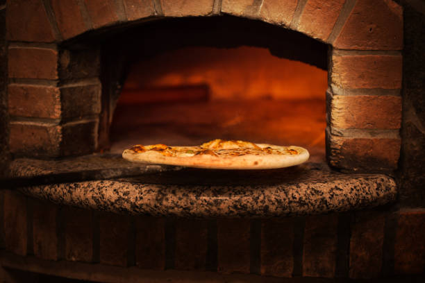 istock taking fresh baked pizza from professional fire oven 1686265136