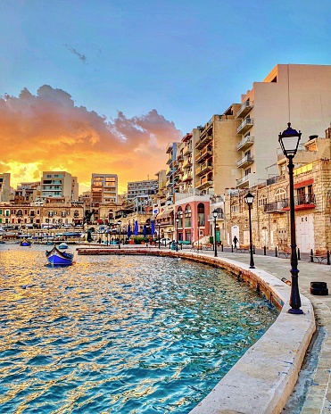 St. Julians, Malta - March 12, 2019: Sunset view across Spinola Bay on the Mediterranean island of Malta.
