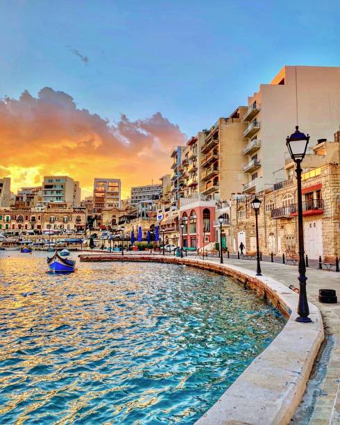 A beautiful sunset view at Spinola Bay, St. Julians, Malta. St. Julians, Malta - March 12, 2019: Sunset view across Spinola Bay on the Mediterranean island of Malta. st julians bay stock pictures, royalty-free photos & images