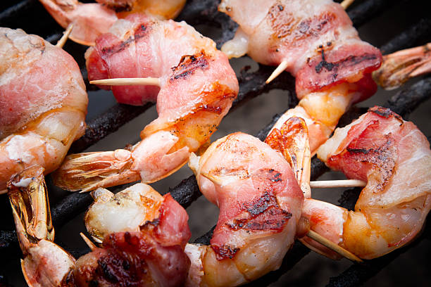 Bacon-Wrapped Shrimp Bacon-Wrapped Shrimp  on a grill bacon wrapped stock pictures, royalty-free photos & images