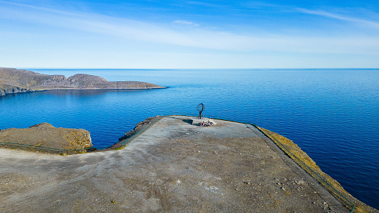 Globe monument sitting on a cliff at the northernmmost point of Europe, the North Cape (Nordkapp)