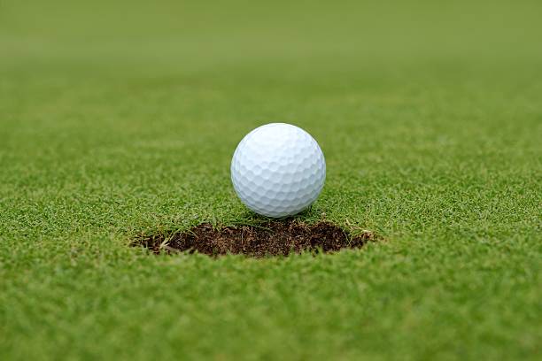 istock Golf, ball lying on the green next to hole 168627148