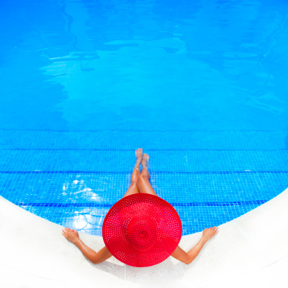 woman relaxing in resort swimming pool