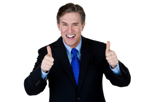 Horizontal composition of a mature businessman gesturing thumbs up and smiling 